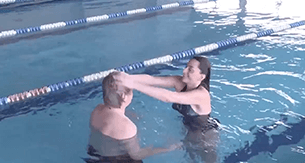 Man & woman in pool wearing the CNC hair prosthesis